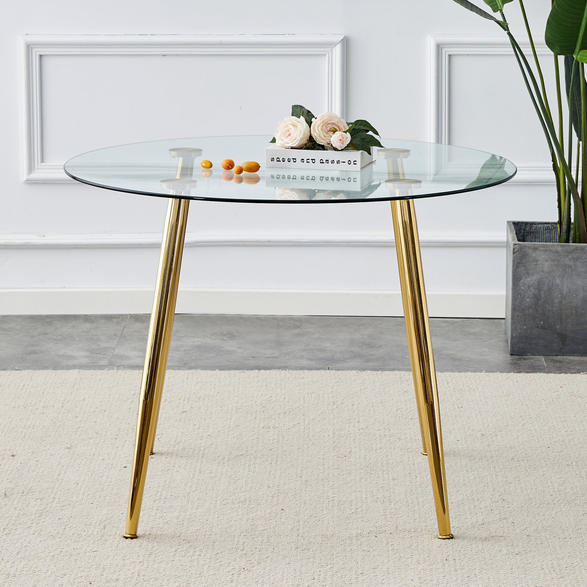 A glass tabletop with a diameter of 40 inches and a modern minimalist circular dining table with gold plated metal legs. 40 '* 40' * 30 ' DT-1164.W1151S00375