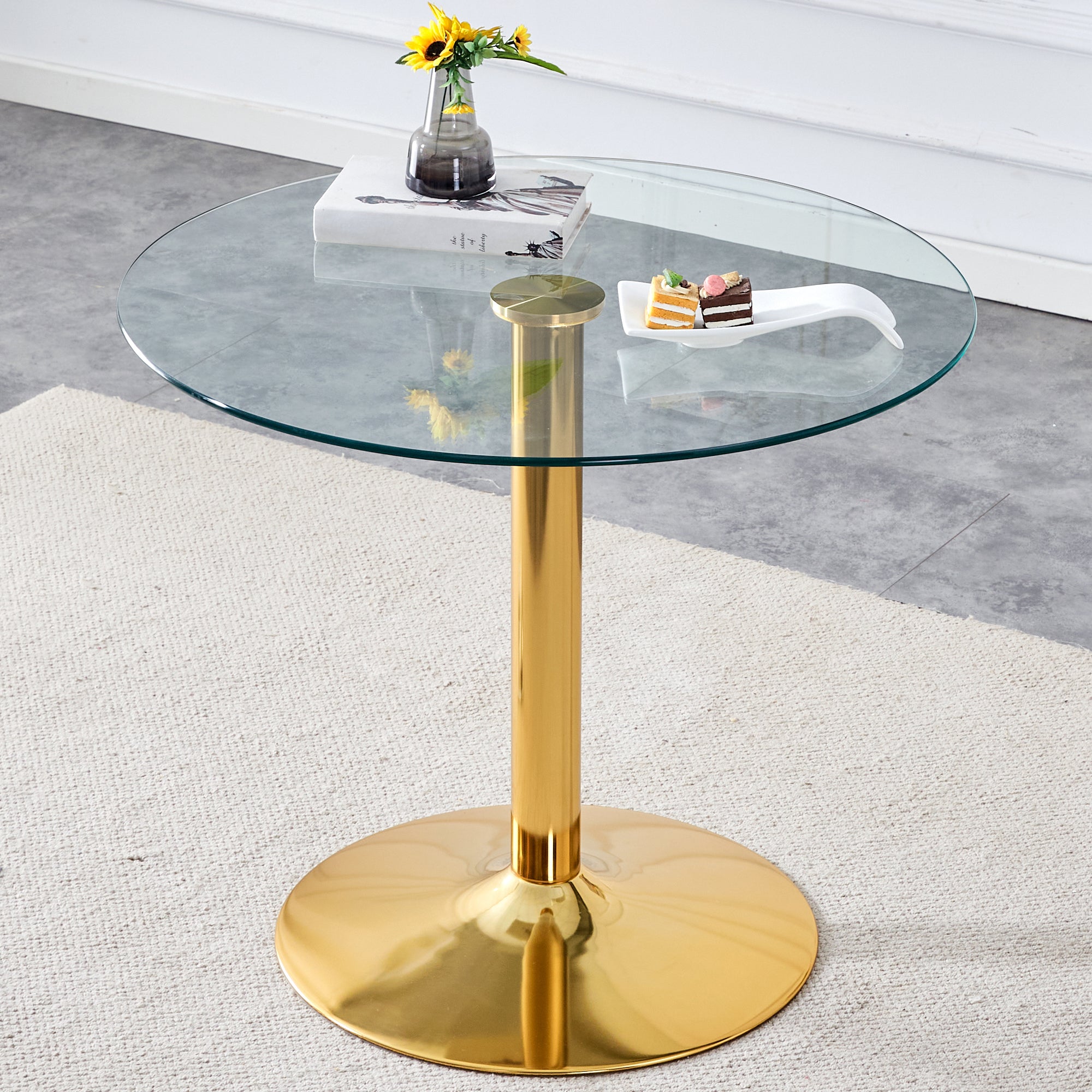 A 35-inch diameter glass top and a modern, minimalist round dining table with gold metal legs. Ideal for dining rooms, living rooms and meeting rooms.W1151P263755